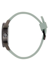 Montre avec un cadran rectangulaire blanc, boîtier en métal sombre et bracelet en silicone vert clair. Comprend une couronne circulaire avec un détail de logo.