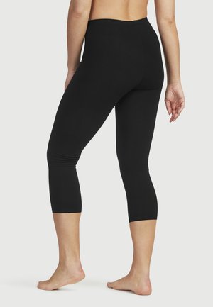 Svarta korta leggings gjorda av ett följsamt, elastiskt tyg med hög midja. Har en figurnära design och sömlös konstruktion.