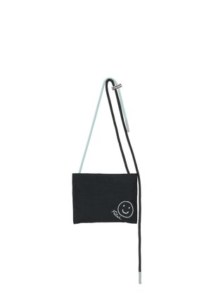 Small black crossbody bag with dual thin straps, one light blue and one black, featuring a white smiley face and cursive text on the front.