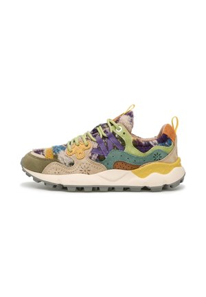 Multicolored sneaker featuring a mix of textured fabrics, including suede and fuzzy materials, with a chunky white sole and unique accent colors.