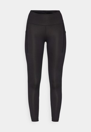Sorte leggings med høy midje, med to sidelommer og en glatt, elastisk tekstur. Designet for komfort og bevegelighet.