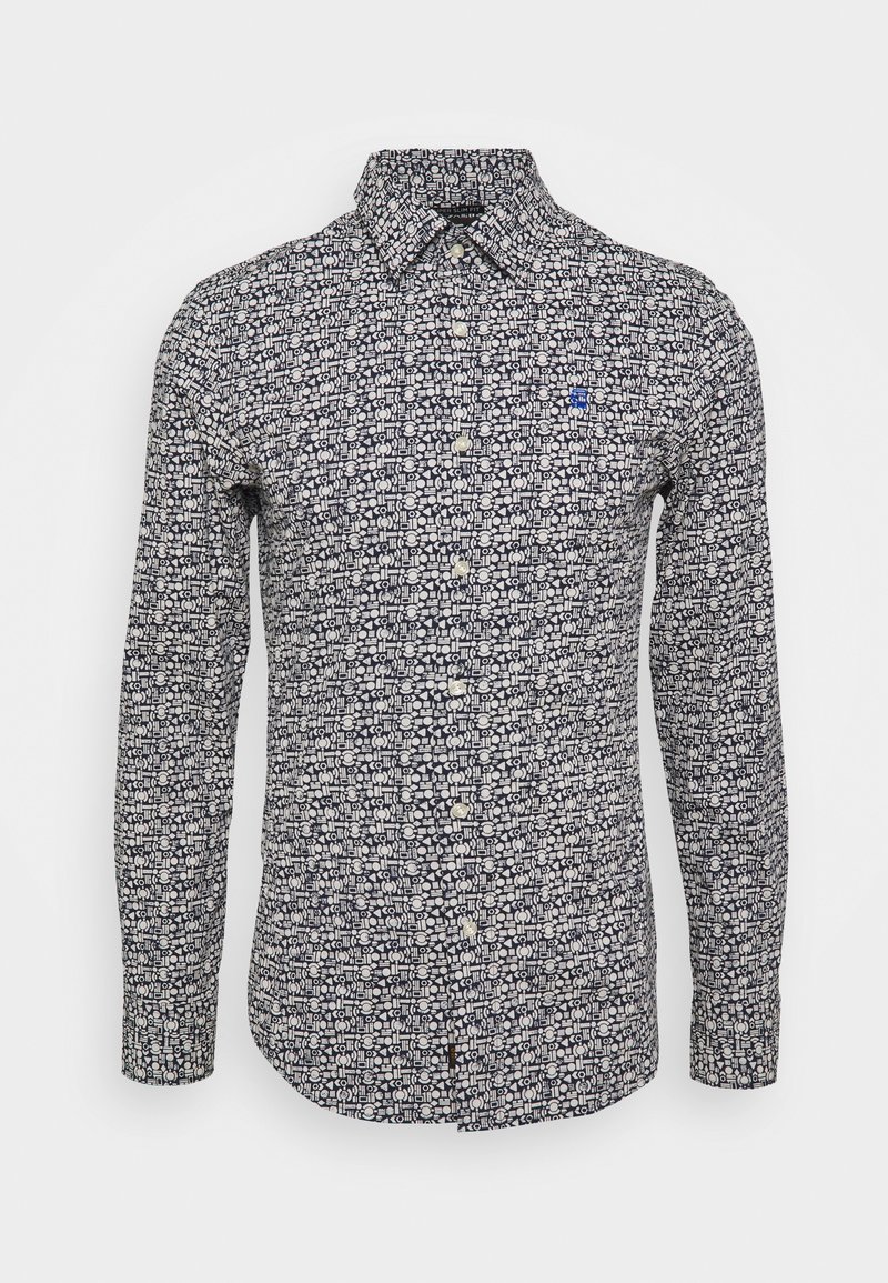 Chemise slim fit à manches longues pour homme avec boutons, motif géométrique noir et blanc et petit logo bleu sur la poitrine gauche.