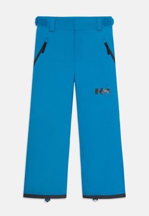 Pantalons de ski imperméables bleus avec poches zippées, pattes de taille ajustables et logo noir HH sur la cuisse droite.
