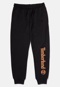 Pantaloni di felpa neri con vita elastica e cordino regolabile. Presentano il logo arancione "Timberland" e l'emblema dell'albero sulla gamba sinistra.