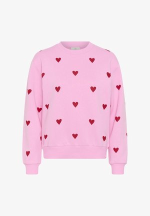 Rozā džemperis ar sarkanu sirsniņu rakstu visā virsmā, ar ribotu aproci, apakšu un apaļu kakla izgriezumu.