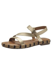 Guldmetalliska platta sandaler med korskorsade remmar, tan fotbädd och vävd jute-sula med marinblå detaljer och spänne.