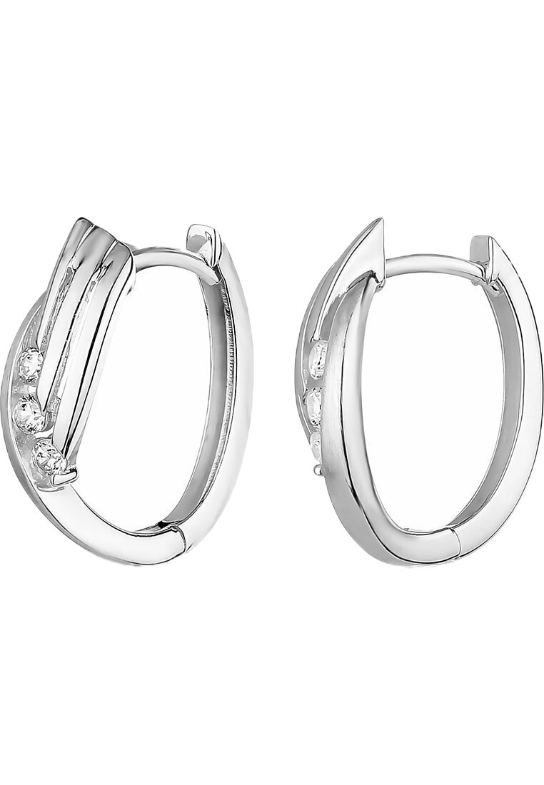 Silver hoop earrings feature a polished finish with a sleek, curved design. Accented by three small, clear gemstones on one side.