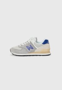 Gray suede and mesh sneaker with purple logo, light blue accents, and a cream midsole. Black rubber outsole with textured details.