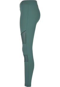Leggings teal a vita alta con un design elegante, caratterizzati da inserti in rete e un tessuto liscio e elasticizzato per comfort e flessibilità.