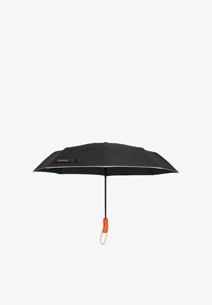 Black compact umbrella with orange handle and wrist strap, partially open against a white background.
