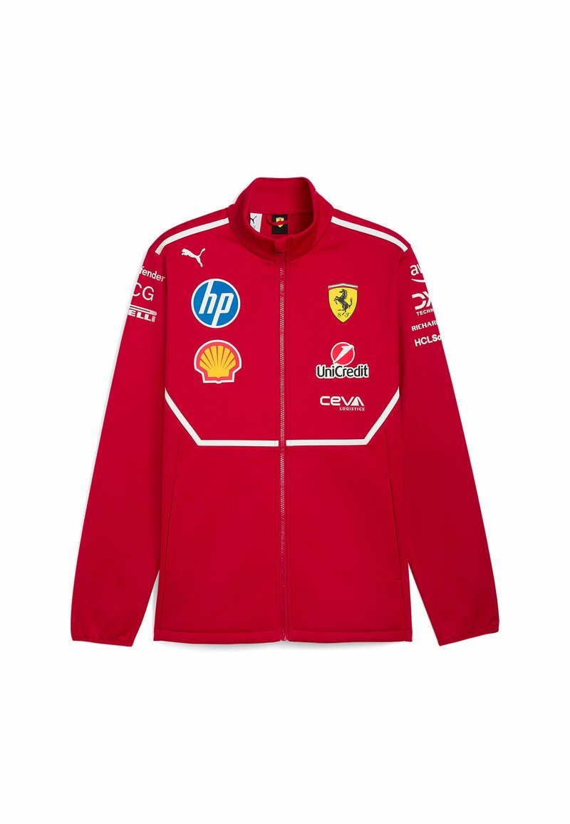 Czerwona kurtka zapinana na zamek z wysokim kołnierzem; posiada loga Ferrari, HP, Shell i innych. Gładki materiał z białymi akcentami i szwami.