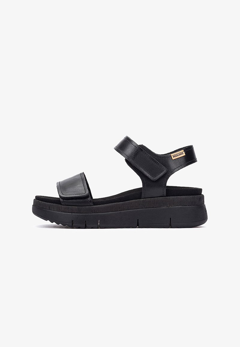 Sandales en cuir noir avec deux fermetures à bride réglables, semelle en caoutchouc épaisse, semelle intérieure texturée et un accent de logo sur la bride arrière.