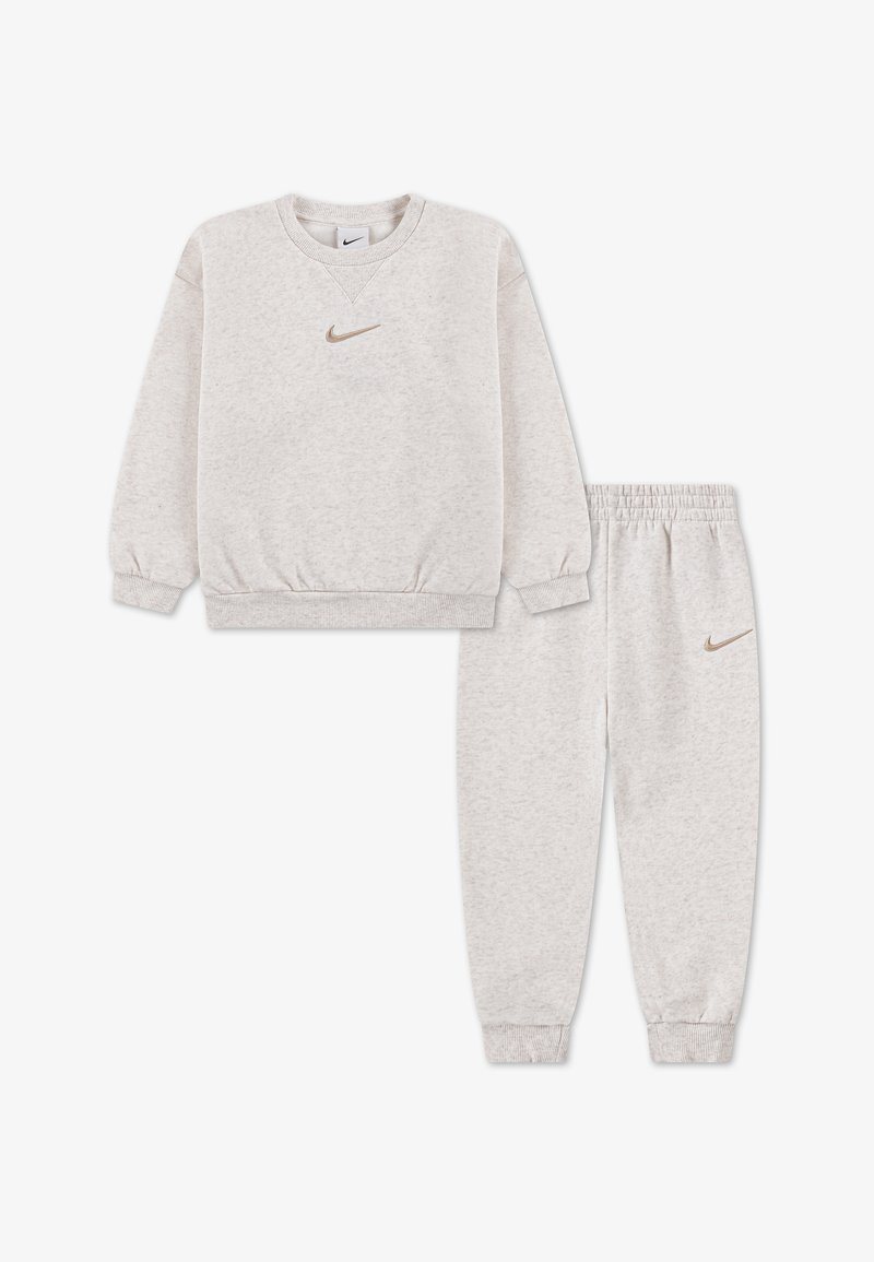 Light gray Nike sweatshirt and matching sweatpants with elastic cuffs and gold Nike logos on chest and thigh.