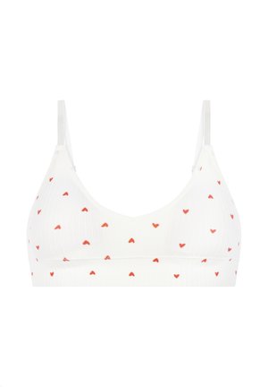 Bralette blanche côtelée avec un décolleté en V, ornée d'un motif de petits cœurs rouges partout. Bretelles réglables, confection sans coutures.