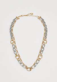 Collana a doppio strato con maglie alternando oro e argento e un piccolo tag rotondo vicino al gancio.