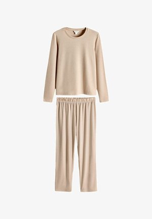 Bežs garo piedurkņu tops un tam atbilstoši bikses, izgatavots no mīkstas, elastīgas auduma. Tam ir apaļa kakla izgriezums un elastīgs jostasvieta komfortam.