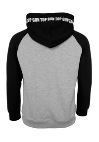 Huvtröja med grå kropp och svarta raglanärmar. Har texten "TOP GUN" på huven. Tillverkad av mjukt tyg, avslappnad passform.