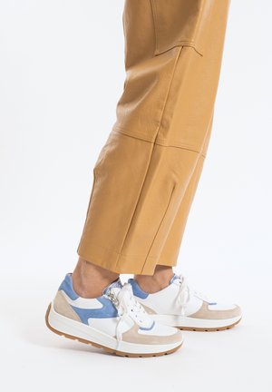 White, blue, and beige sneakers featuring a textured upper, lace-up design, and a rubber sole with a slight platform.