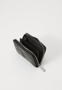 Black zippered wallet made of quilted leather, featuring multiple compartments and a silver zipper accent.