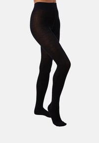 Black opaque tights with a smooth texture, featuring a wide elastic waistband. They cover the legs entirely to the feet.