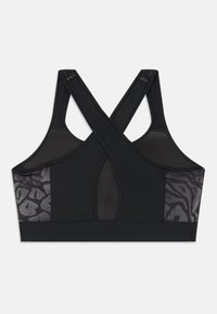Musthave mustäräpp ja võrkkangast seljaosa, millel on ristukiired rihmad. Küljel on sile, tekstuuriga loomamuster. Pehme ja veniv materjal.