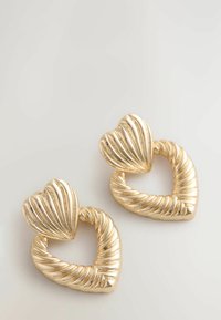 Gold-tone earrings shaped like intertwined hearts, featuring ribbed textures and a smooth, polished finish.