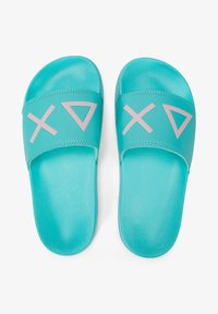 Turquoise slide sandals with a textured finish. Features a wide strap adorned with pink geometric symbols. Lightweight and casual design.