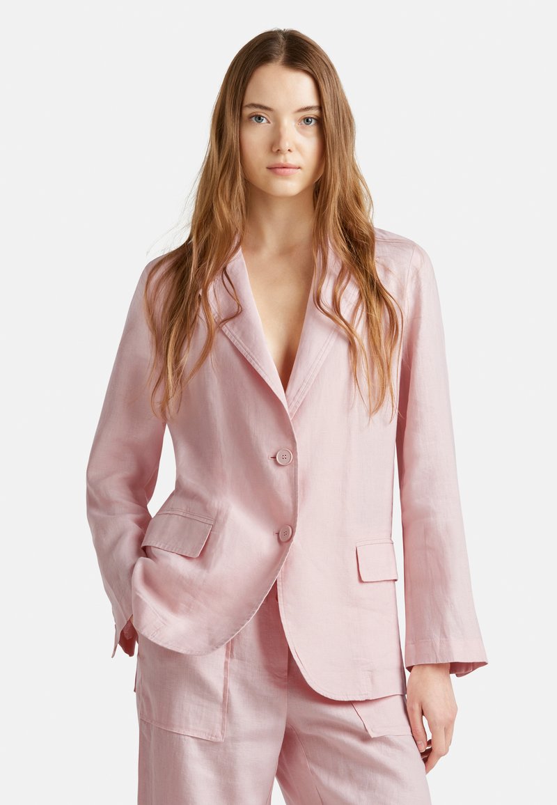 Blazer de lino rosa claro con dos bolsillos delanteros, solapas de pico y dos botones, que presenta un corte relajado y una superficie ligeramente texturizada.