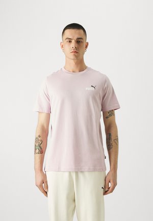 Camiseta de algodón rosa claro con mangas cortas, escote redondo, pequeño logo negro de Puma en el pecho y un ajuste relajado.