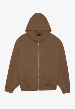 Braune Zip-Hoodie mit einer Kapuze mit Kordelzug, Fronttaschen und gerippten Bündchen. Hergestellt aus weichem Stoff mit einer glatten Textur.
