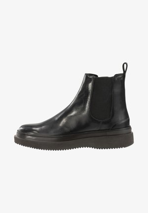 Botte Chelsea en cuir noir avec panneaux latéraux élastiques, semelle en caoutchouc épaisse et languette à l'arrière.