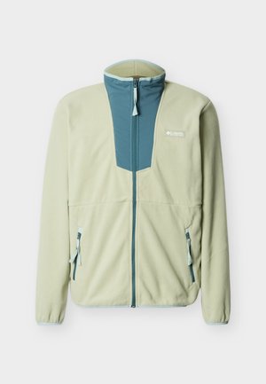 Ανοιχτό πράσινο μπουφάν από φλις με μπλε πλαίσιο από νάιλον στο μπροστινό μέρος, κλείσιμο με φερμουάρ, δύο μπροστινές τσέπες και αντιθετικές γαλάζιες λεπτομέρειες.