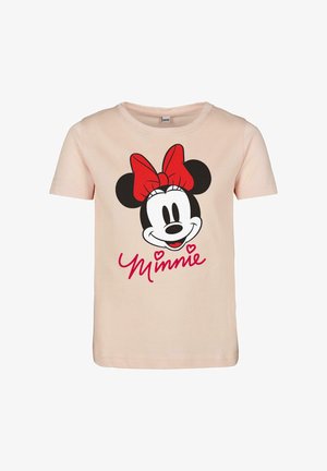 T-shirt rosa chiaro in cotone con una grafica di una testa di topo sorridente con un fiocco rosso e la scritta "Minnie" in rosso sotto. Maniche corte.