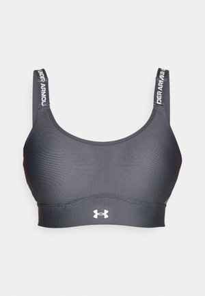Juoda sportinė liemenėlė, pagaminta iš glotnaus, elastingo audinio. Yra plačios petnešėlės su "Under Armour" tekstu ir baltu logotipu priekyje, centre.