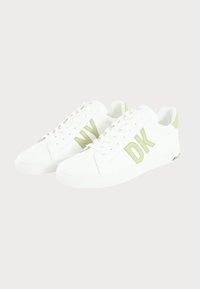 White sneakers with a smooth texture, featuring green accents and "DK" logo. Lace-up design, round toe, and rubber outsole.