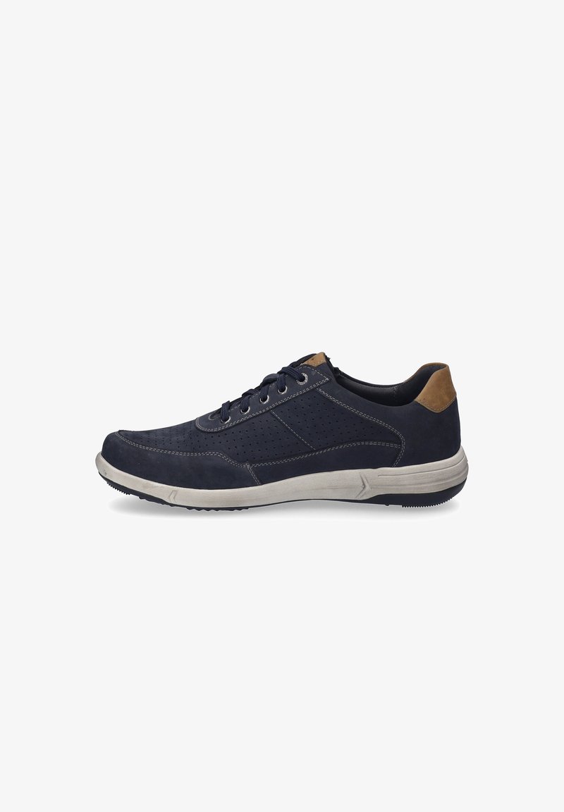 Navy blue athletic shoe with perforated design, contrasting tan heel, and beige sole. Features lace closure and a textured upper.