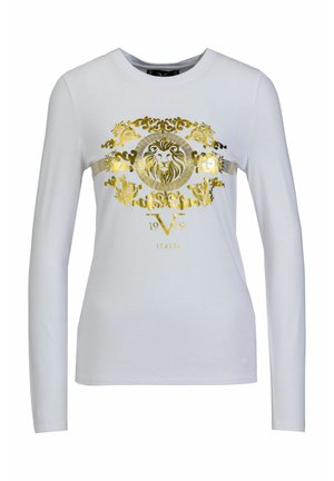 Langärmliges weißes T-Shirt mit einem goldenen Löwendesign, kunstvollen Details und dem Text "1969 ITALIA", gefertigt aus weichem Baumwollmaterial.