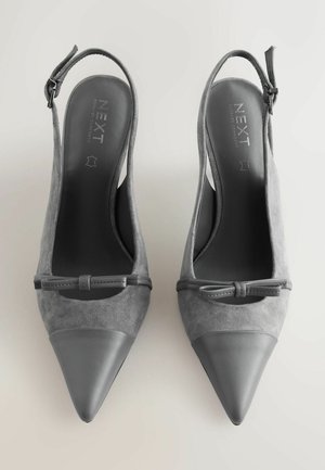 Gray slingback heels made of suede and leather with pointed toes, decorative bow detail, and a smooth, matte finish.