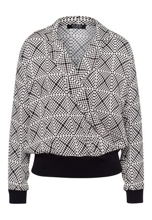 Schwarz-weiß gepunktete Bluse mit Wickeldesign, langen Ärmeln und einem schwarzen, gerippten Saum. Leichter Stoff mit glatter Textur.