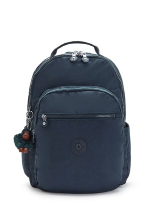 Navy fabric backpack with dual zippers, front pocket, and a keychain monkey charm. Features a round logo and padded straps.