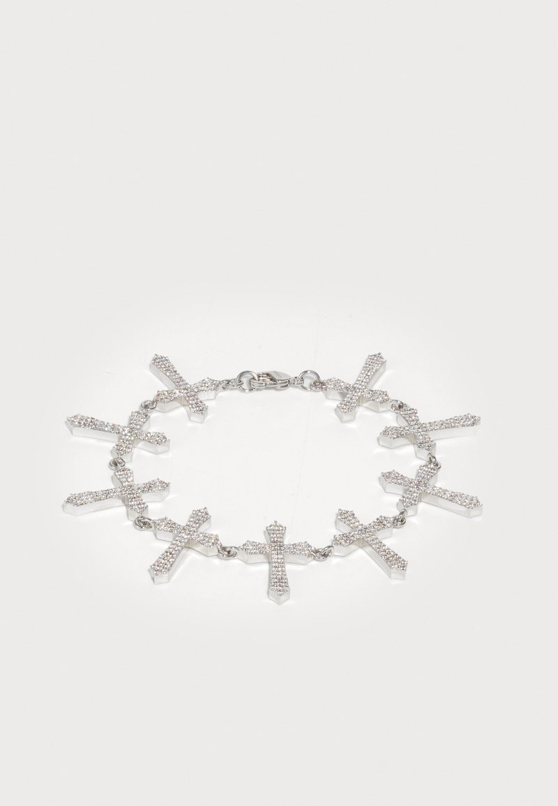 Hõbedane randmeaed, millel on üheksa omavahel seotud risti, igaühes väikesed selged kristallid, valge tausta peal.