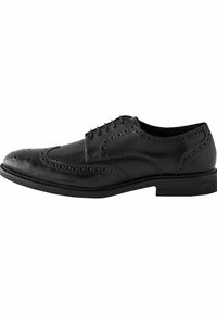 Chaussure habillée en cuir noir avec un design à la pointe d'aile, des détails en brogue, un bout rond et une semelle noire fine. Les lacets passent à travers six œillets.