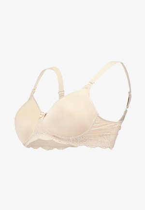 Beige naadloze bh met zachte padded cups, kantdetails op de band, verstelbare bandjes en een haak-en-oogsluiting op de rug.