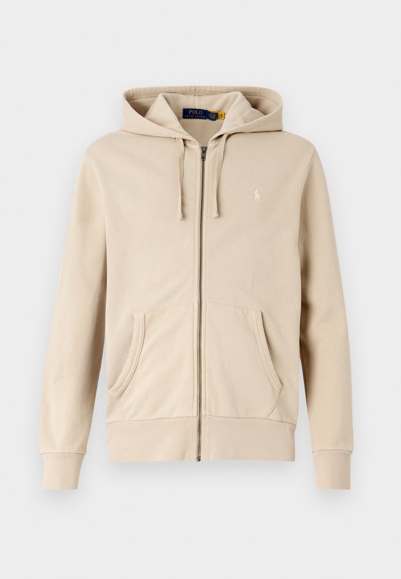 Beige rits hoodie gemaakt van zachte stof, met een trekkoord capuchon, twee voorzakken, geribde manchetten en een klein logo op de borst.