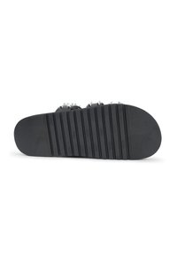 Black sole of a sandal with horizontal ribbing for traction, featuring metal studs along the upper strap for added detail.