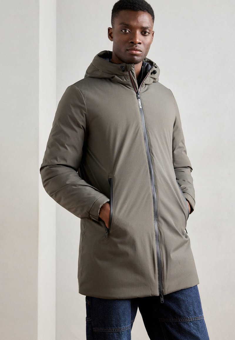 Lightweight gray-green puffer jacket with a hood, front zipper, and side pockets. Features a smooth texture and minimalist design.