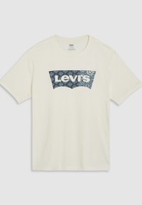 Korte ermer, kremfarget bomulls-t-skjorte med blå, mønstrete Levi's-logo grafikk foran, med rund hals og avslappet passform.
