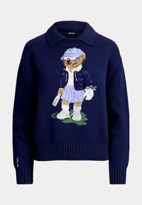 Pull bleu marine avec col, featuring un ours tricoté portant une tenue de golf et tenant un club de golf et une bouteille d'eau.