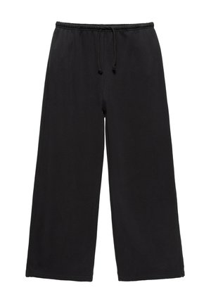 Pantalon de survêtement noir à jambes larges avec ceinture élastique et cordon de serrage, en tissu doux, présenté sur fond blanc.