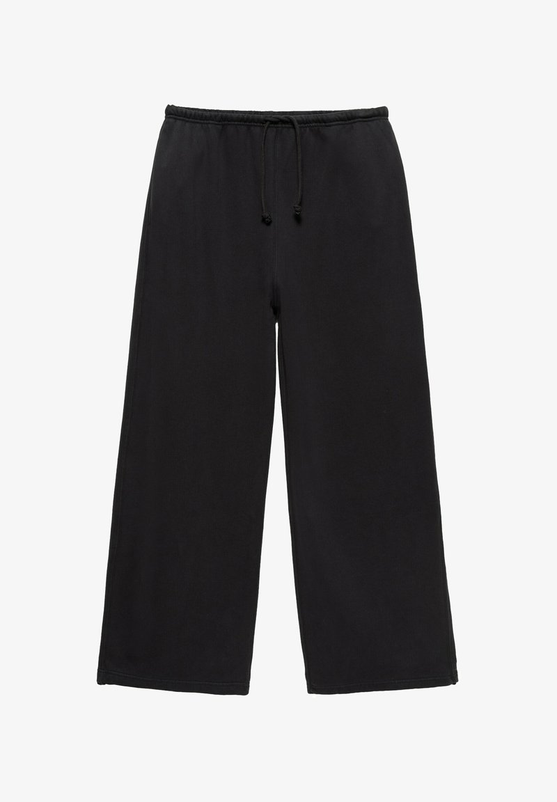 Pantalon de survêtement noir à jambes larges avec ceinture élastique et cordon de serrage, en tissu doux, présenté sur fond blanc.